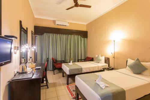 Postel nebo postele na pokoji v ubytování Hotel Coorg International