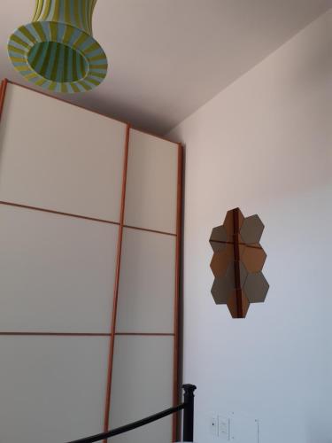 a mirror on a wall next to a wall at Campese Apartments in Campese