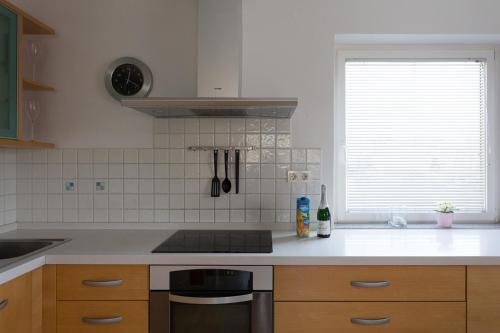 a kitchen counter with a stove and a window at Vacation Home Sofia in Zgornje Gorje