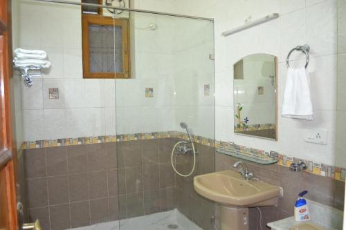 a bathroom with a sink and a shower at Raj Cottage Ganga Vatika in Rishīkesh