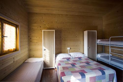 Кровать или кровати в номере Camping Rialto