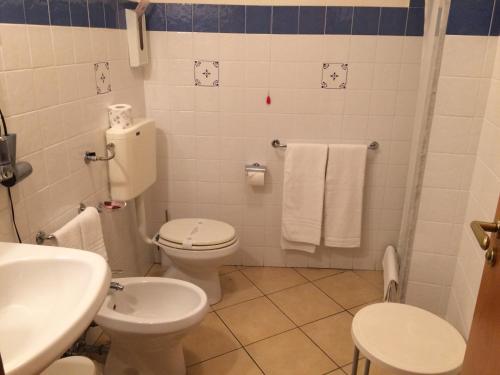 a bathroom with a toilet and a sink at Hotel Relais Modica in Modica