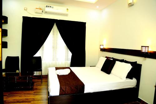 Amritham Holidays Homestay Trivandrumにあるベッド
