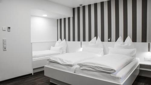 מיטה או מיטות בחדר ב-OK Das Businesshotel