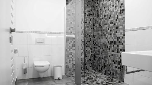 a black and white bathroom with a toilet and a sink at OK Das Businesshotel in Braunschweig