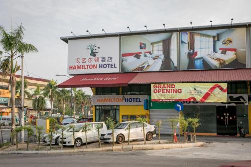 a building with cars parked in front of it at Hamilton Hotel Kajang in Kajang