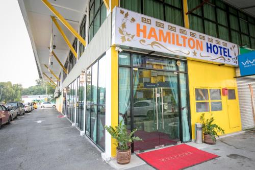 a yellow building with a hamilton hotel sign on it at Hamilton Hotel Kajang in Kajang