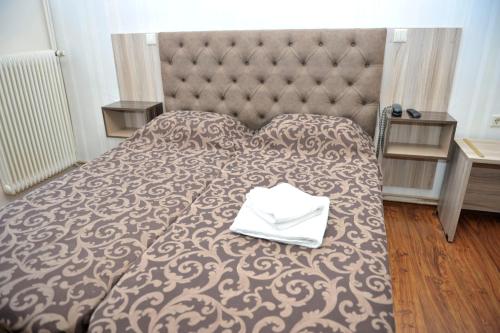 Postel nebo postele na pokoji v ubytování Hotel Vergina