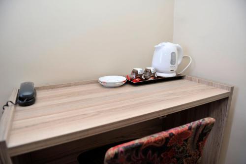 a table with a coffee maker on top of it at Hotel Vergina in Alexandroupoli
