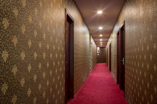 a corridor with a red carpet in a hallway at Hamilton Hotel Kajang in Kajang