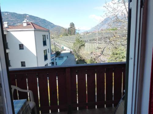 a balcony with a view of a building and a street at Hotel Haselried in Tirolo