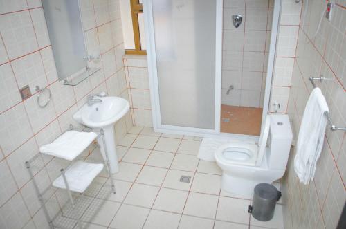 a bathroom with a toilet and a sink at Union Hotel Apartments in Addis Ababa
