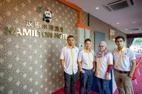 a group of men and a woman standing in a room at Hamilton Hotel Kajang in Kajang