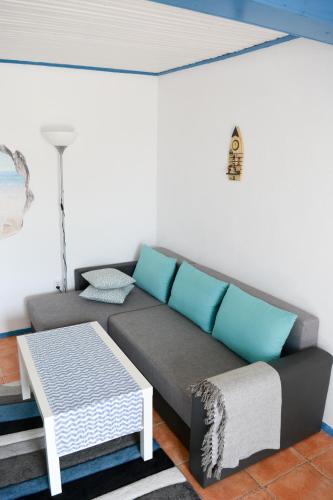 a living room with a couch and a table at Sailors Guest House Jurilovca in Jurilovca