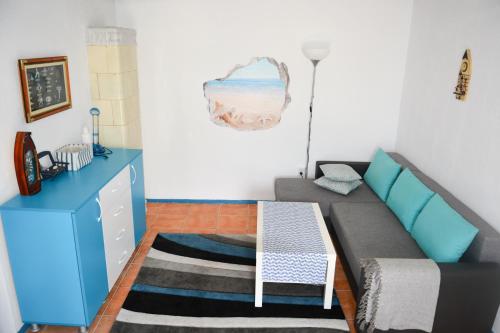 a living room with a couch and a table at Sailors Guest House Jurilovca in Jurilovca