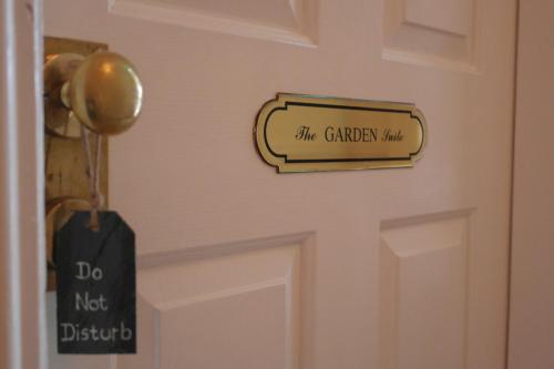 a door with a do not disturb sign on it at Hazelwood Lodge in Ballyvaughan