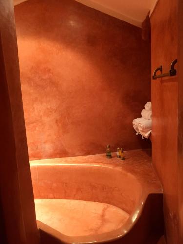 a bathroom with a sink and a bath tub at Riad Al Loune in Marrakech