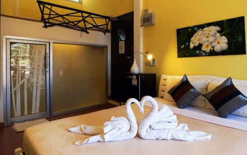 two swans sitting on top of a bed at Phuket Paradiso in Chalong 
