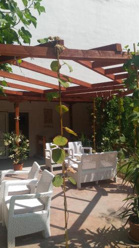 a group of white chairs and tables under a pavilion at Aura in Primorsko