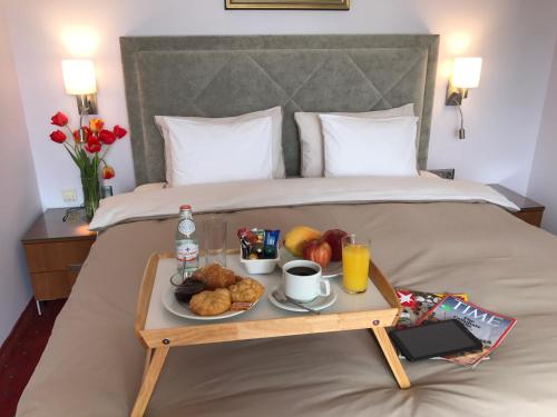 a tray of breakfast foods on a bed at Art 'Otel in Sofia