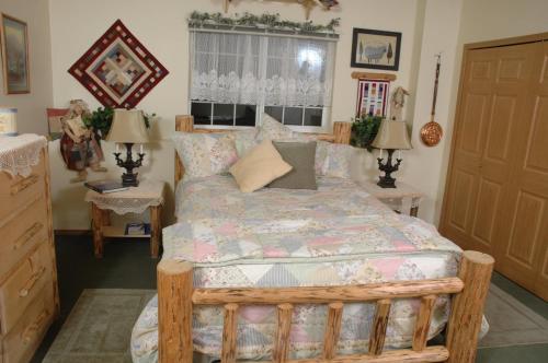 a bedroom with a bed and two tables and two lamps at Alaska's Lake Lucille Bed & Breakfast in Wasilla