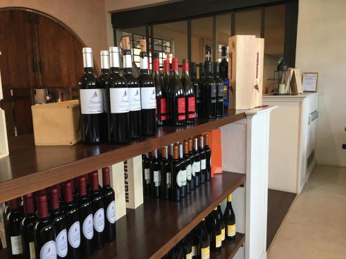 a bunch of bottles of wine on a shelf at Albergo Rondò in Acqui Terme