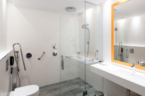 a bathroom with a shower and a toilet and a sink at Catalonia Mikado in Barcelona