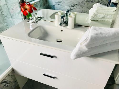 a bathroom with a white sink and a mirror at Hotel Le Festival in Cannes