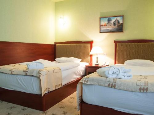 Ένα ή περισσότερα κρεβάτια σε δωμάτιο στο Golden Valley Hotel