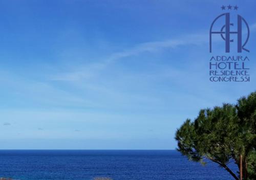 a view of the ocean with a tree in the foreground at Addaura Village e Congressi in Mondello