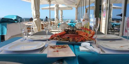 a table with a lobster sitting on top of it at Casa Vintage Guest House in Peniche