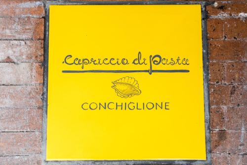 a sign for a restaurant on a brick wall at Capriccio Di Pasta Residence & Spa in Gragnano