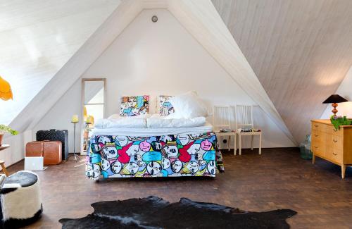 a bedroom with a bed in a attic at Studio på loftet i Sankt Olof in Sankt Olof