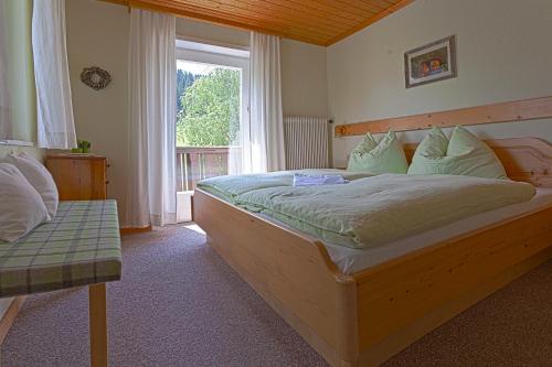 a bedroom with a large bed and a window at Moserhof in Haus im Ennstal