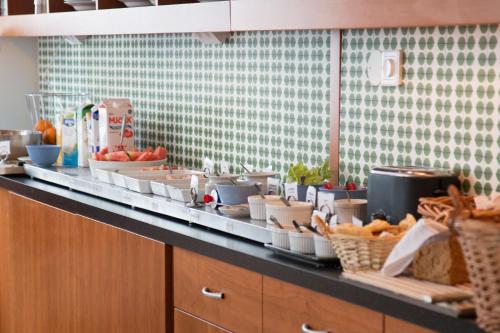 a kitchen counter with a bunch of food on it at Hotell Aston in Karlskrona
