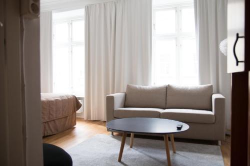 a living room with a couch and a coffee table at Hotell Aston in Karlskrona