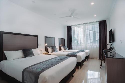 Ένα ή περισσότερα κρεβάτια σε δωμάτιο στο Darwin City Hotel