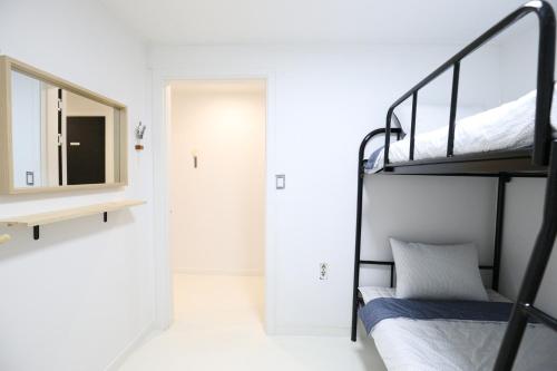a bedroom with a bunk bed and a mirror at Zibro S in Seoul