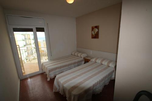 カンブリルスにあるApartamento Regueralのバルコニー付きの客室内のベッド2台