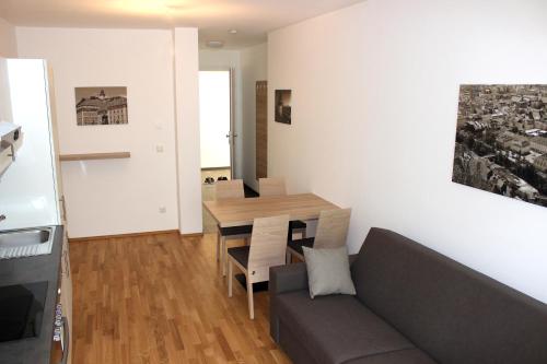 a living room with a couch and a table at Albert Schweitzer Center Graz in Graz