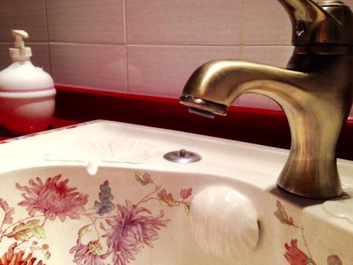 a bathroom sink with a floral pattern on it at Sant Jaume in Alcudia
