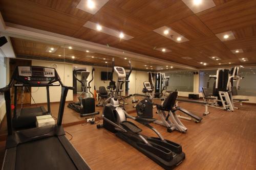 a gym with several exercise bikes and treadmills at Minerva Grand Secunderabad in Hyderabad