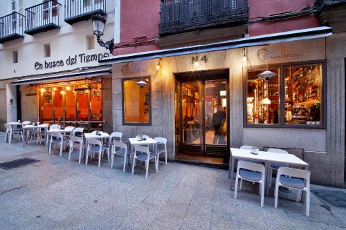 a row of tables and chairs outside of a restaurant at Apartamentos El Tiempo Madrid in Madrid