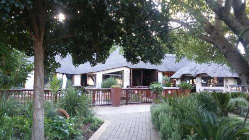 a house with a fence in front of it at Gabbata Lodge in Leeuwfontein