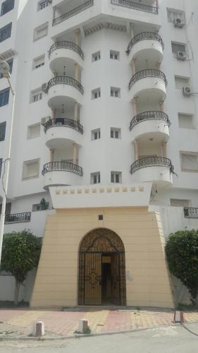 a large white building with balconies on top of it at Residence Ahlem in El Aouina