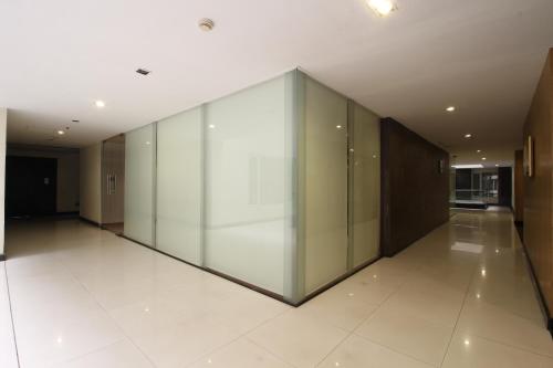 a large hallway with glass walls in a building at Minerva Grand Secunderabad in Hyderabad
