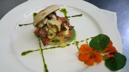 a white plate with a piece of food on it at Gabbata Lodge in Leeuwfontein