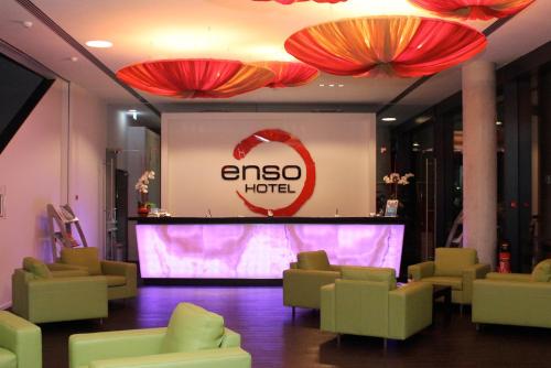 a living room filled with furniture and a tv at enso Hotel in Ingolstadt