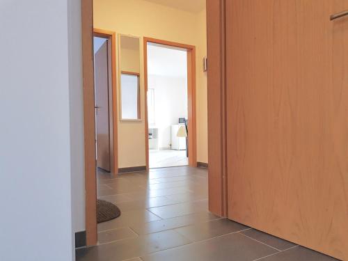 a hallway with two doors and a tile floor at Apartments Overath in Overath