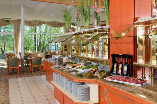 a buffet line in a restaurant with fruits and vegetables at Hotel Sonnenhügel in Bad Kissingen
